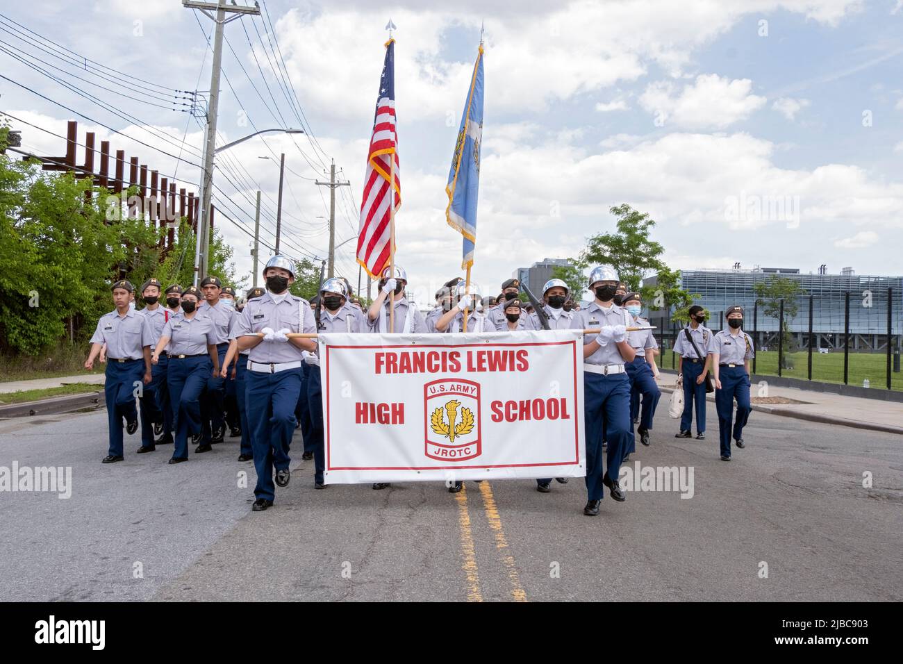The Francis Lewis High School JrOTC marching in the College Point, Queens Memorial Day Parade. A diverse group of teens with most wearing masks. Stock Photo
