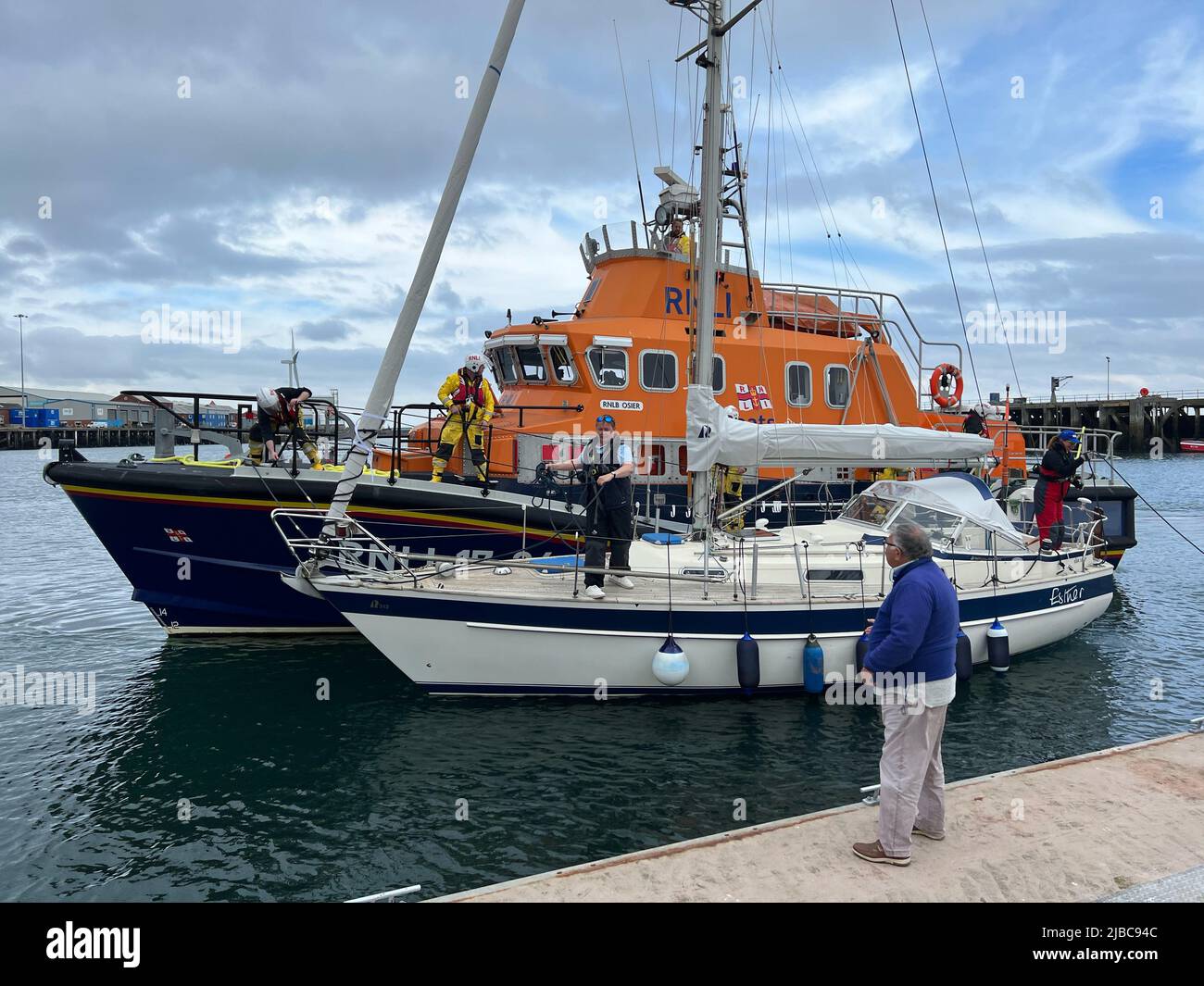 Blyth, UK. 05th June, 2022. RNLI Lifeboat bringing in a sailing boat into Blyth Harbour Credit: Miroslav Valasek/Alamy Live News Stock Photo