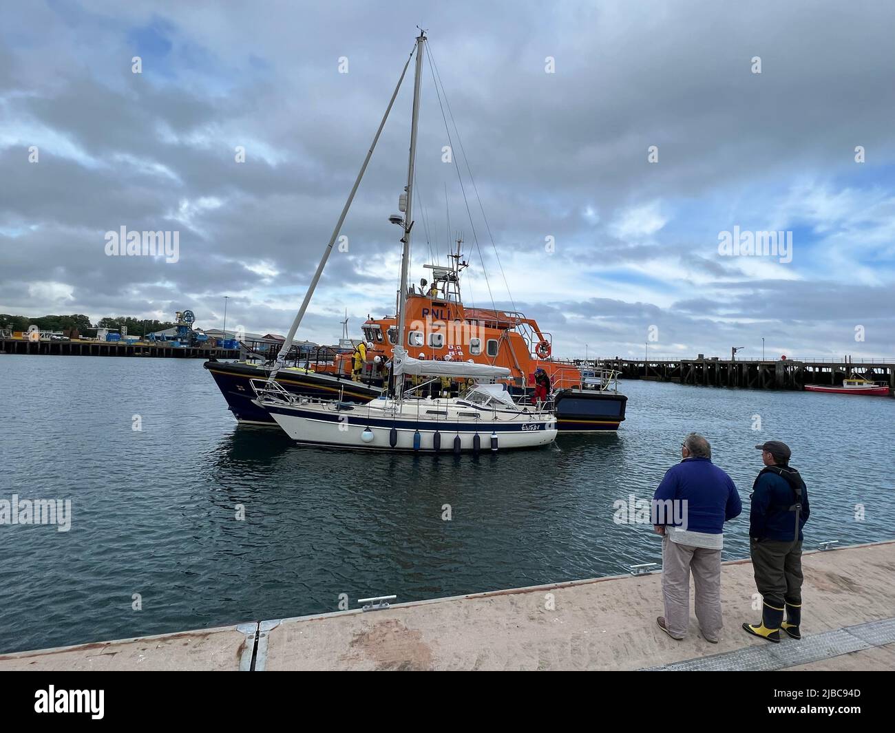 Blyth, UK. 05th June, 2022. RNLI Lifeboat bringing in a sailing boat into Blyth Harbour Credit: Miroslav Valasek/Alamy Live News Stock Photo