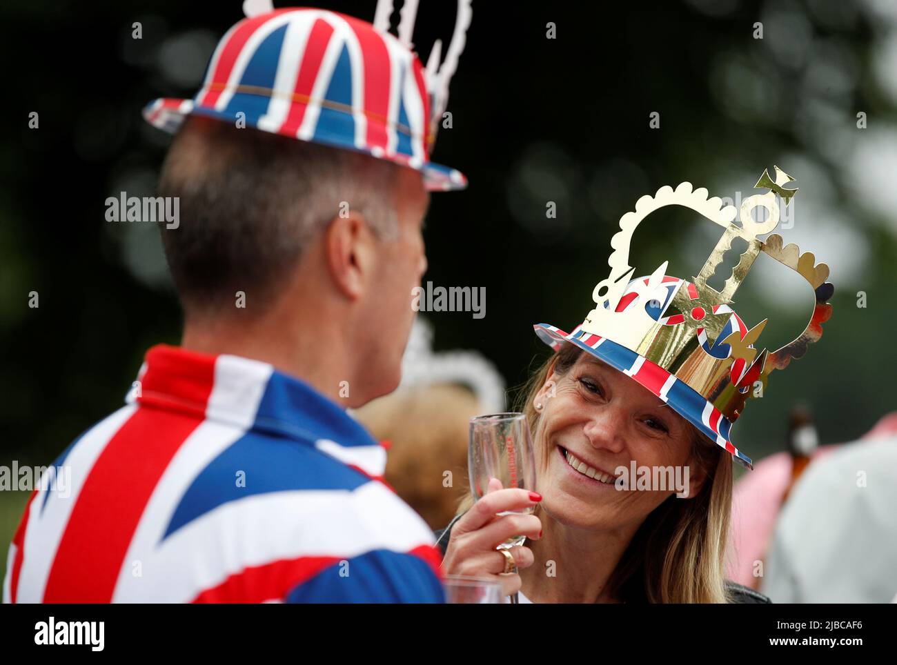 A woman dressed in an outfit with a Union Jack theme looks on as people  take part in the Big Jubilee Lunch on The Long Walk as part of celebrations  marking the