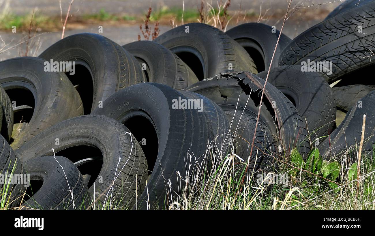 Dump of old worn out tyres on farmland. UK. Stock Photo