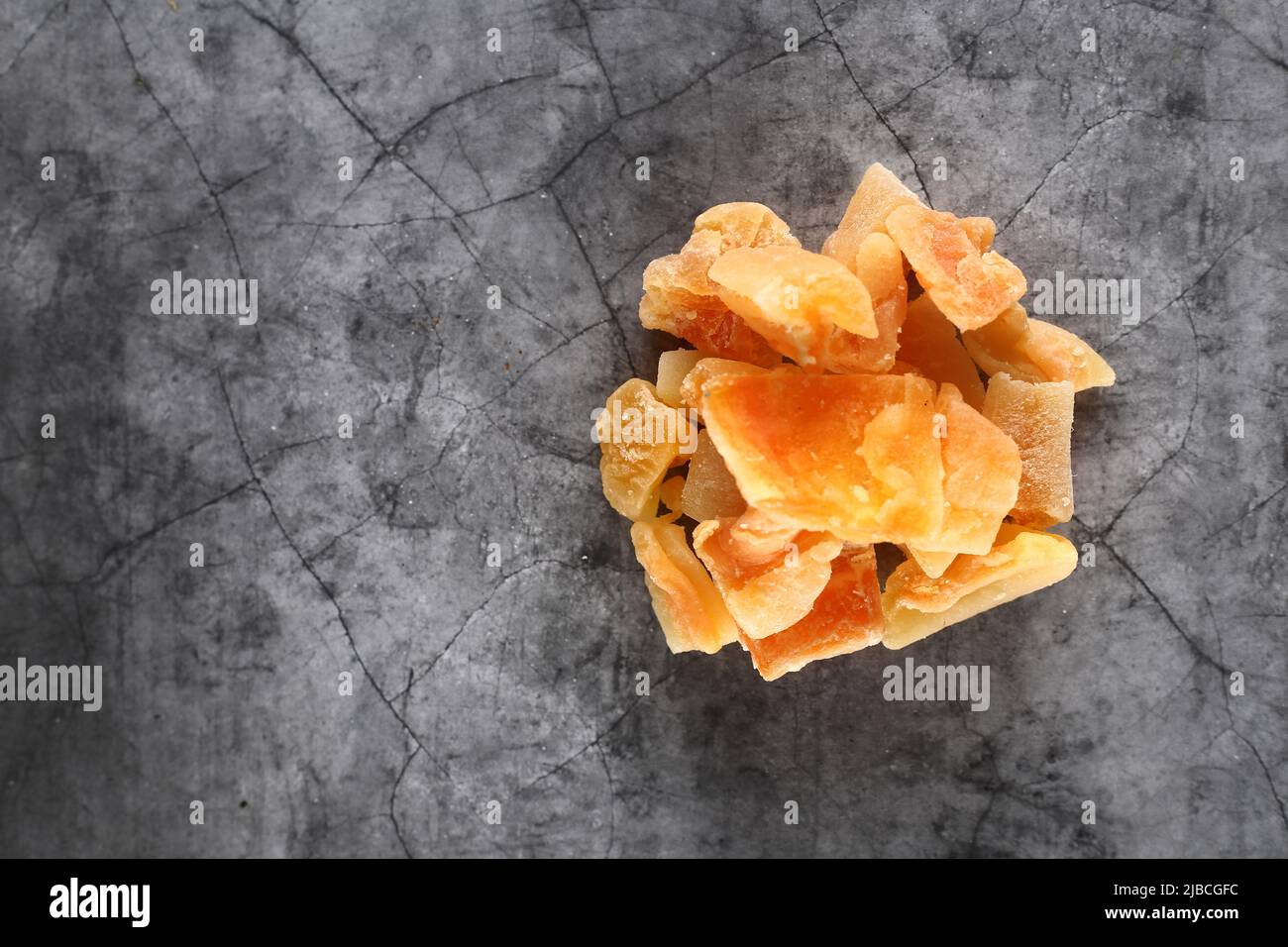 Healthy eating concept - a pile of candied cantaloup (rock melon) isolated on gray background flat lay. Image contains copy space. Image contains copy Stock Photo