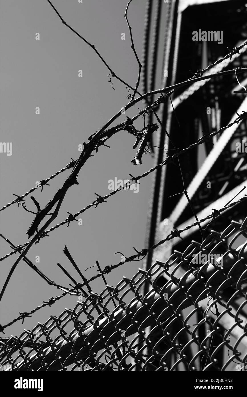 Razor sharp barbed wire fence protecting the industrial area in black ...