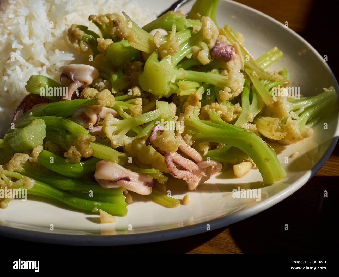 A plate of squid with Chinese cauliflower from a restaurant in Elmhurst, Queens, New York, USA Stock Photo