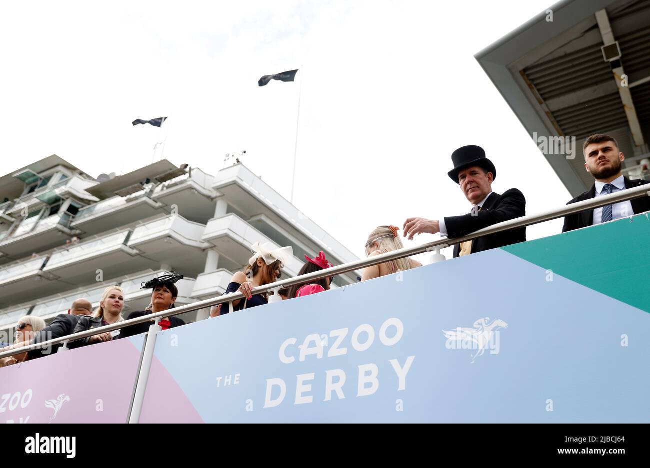 Racegoers and Cazoo branding on Derby Day during the Cazoo Derby