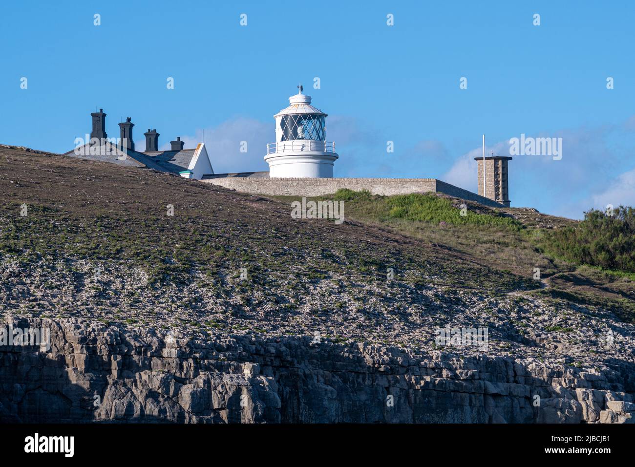 Anvil Point Lighthouse viewed from the sea on the Jurassic Coast of Dorset near Swanage, England, UK Stock Photo