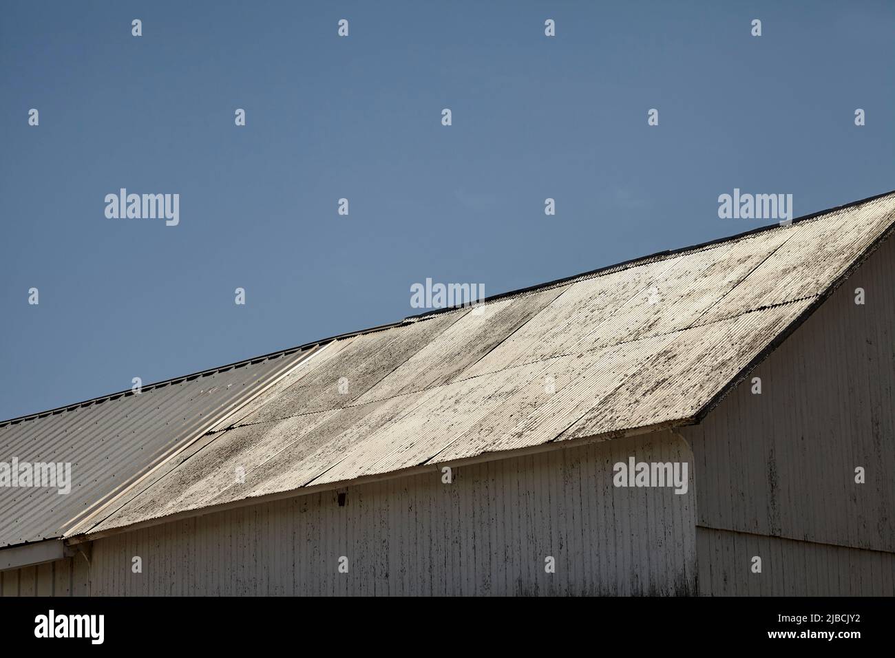 A metal barn roof reflecting in the sun Stock Photo