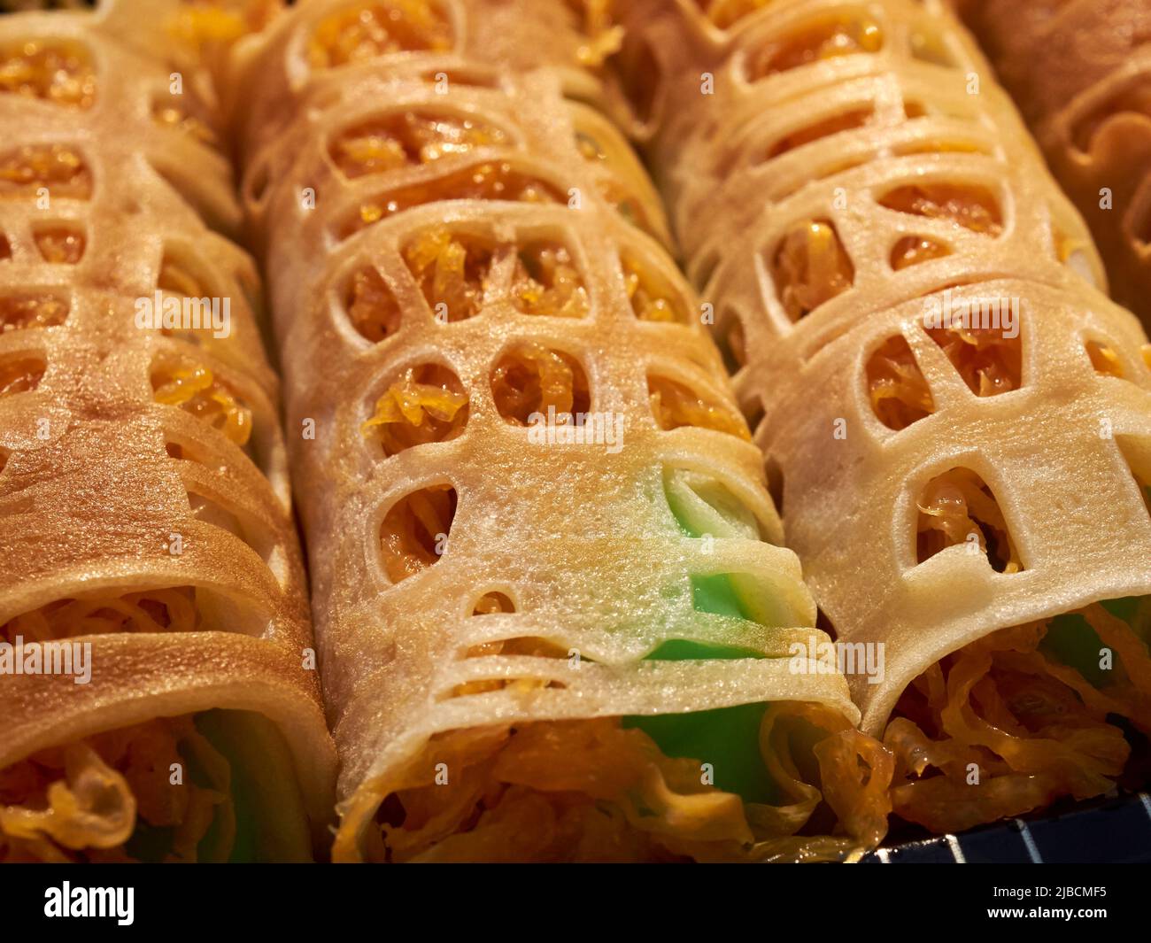 Thai rolled crepes filled with pandan cream from a vendor in Little Thailand, Elmhurst, Queens, New York City, USA Stock Photo