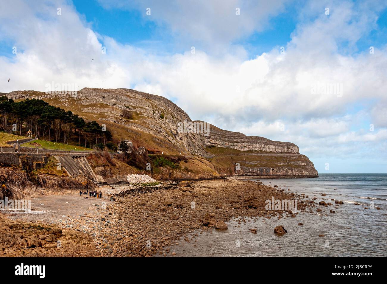 The striking headland of Great Orme jutting into the Irish Sea has landscaped gardens and terraces covering the lower steeply sloping southern sides Stock Photo