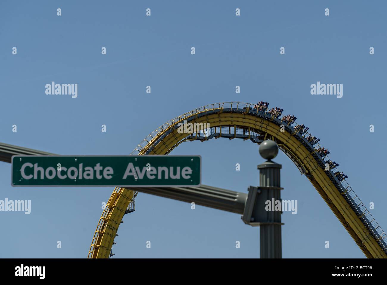 Hershey Pennsylvania, May 30, 2022: Chocolate Avenue street sign with Hersheypark roller coaster in the background. Stock Photo