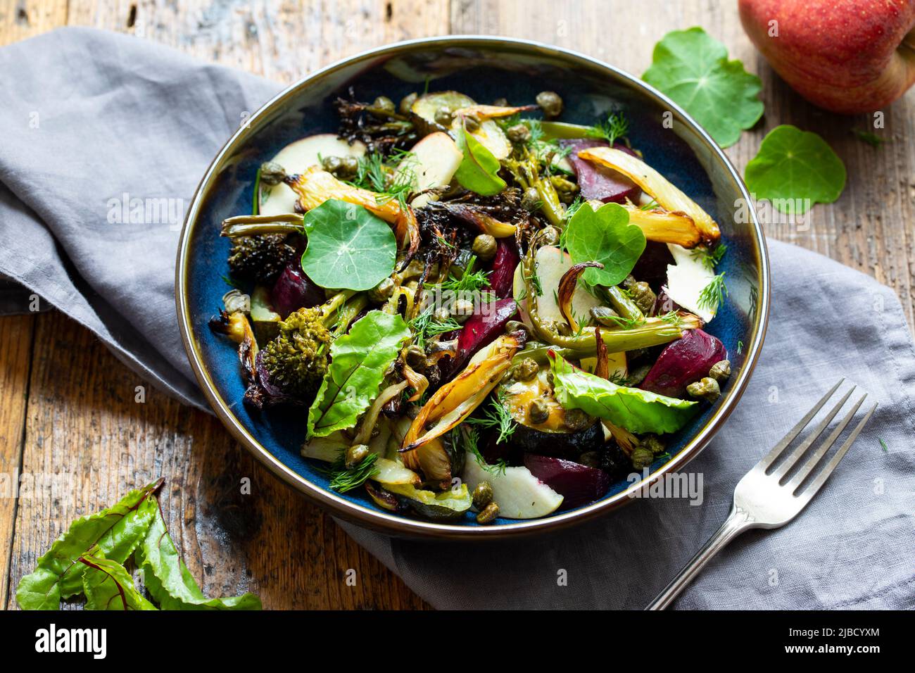 Warm salad with roast beetroor, broccoli, apple, fennel and crispy capers Stock Photo