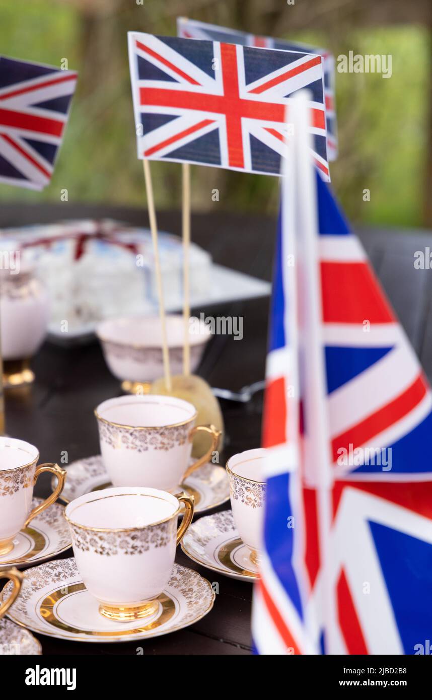 Concept Britishness or British; bone china tea cups and union jacks, the flag of the UK,  as part of the Platinum Jubilee celebrations, Suffolk UK Stock Photo