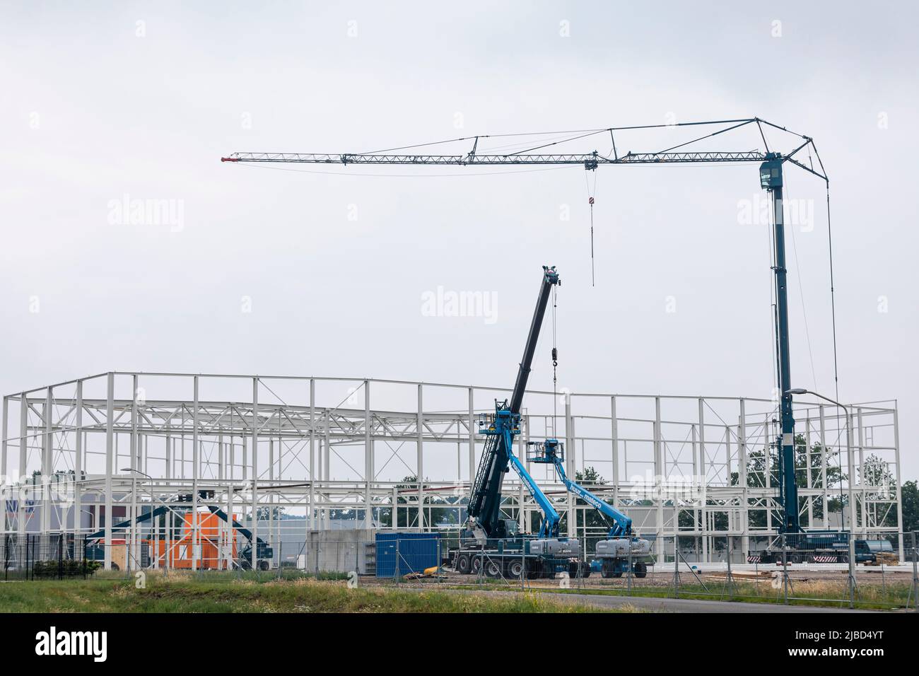 New building of an industrial hall in the Netherlands with metal skeleton rising. Stock Photo