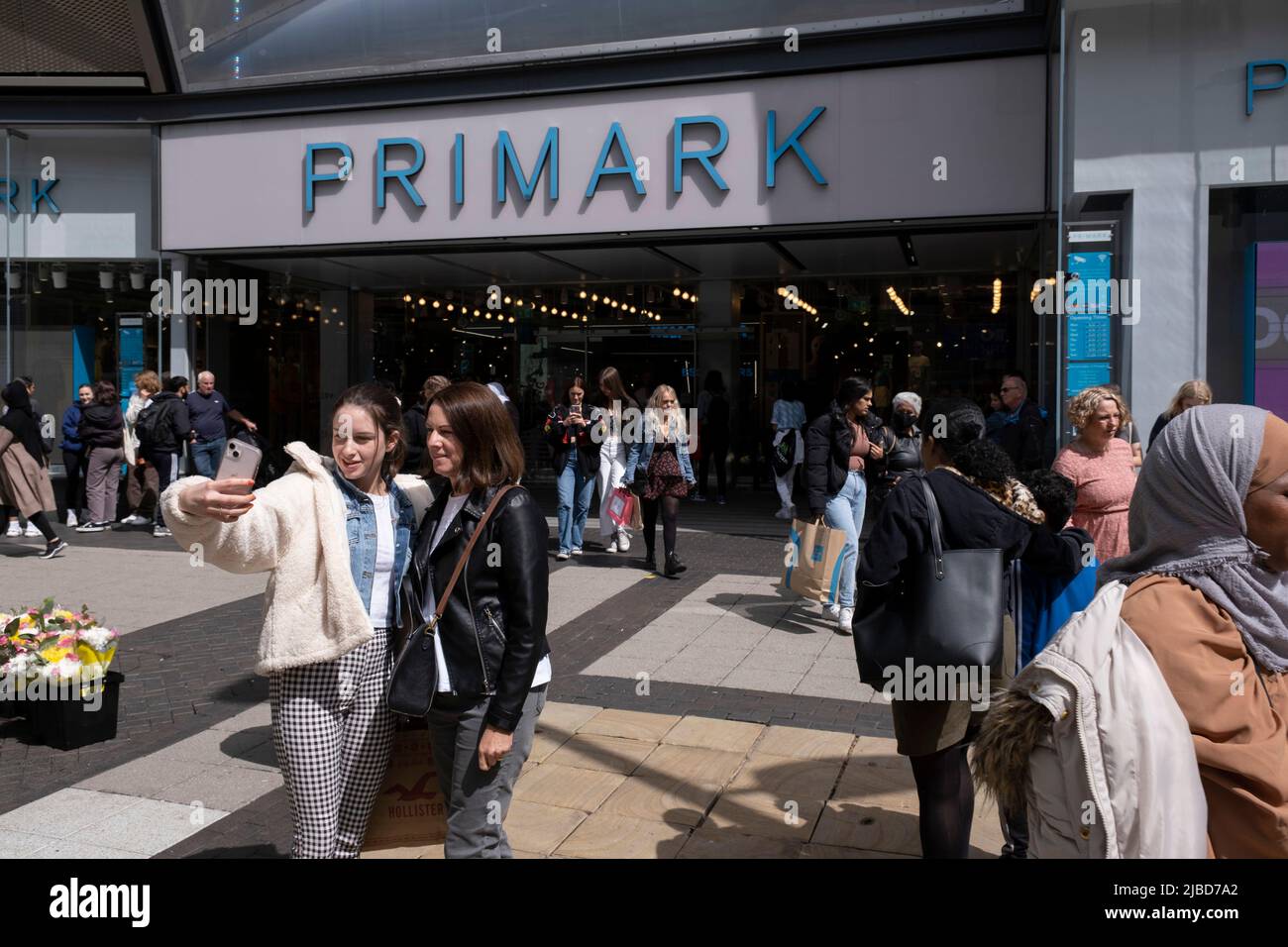 People shopping at Primark in the city centre shopping district on 30th May 2022 in Birmingham, United Kingdom. The Birmingham store is the biggest Primark in the World, and one of their flagship stores, selling clothes at the budget end of the market. The company sources cheaply, using simple designs and fabrics in the most popular sizes and buys stock in bulk. Stock Photo