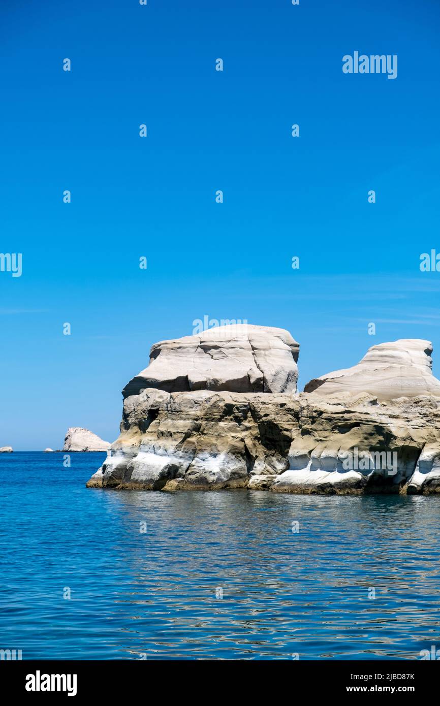 Sarakiniko at Milos island, Cyclades Greece. White rock cliffs and caves over blue sea. Lunar rock landscape, clear blue skyy Stock Photo