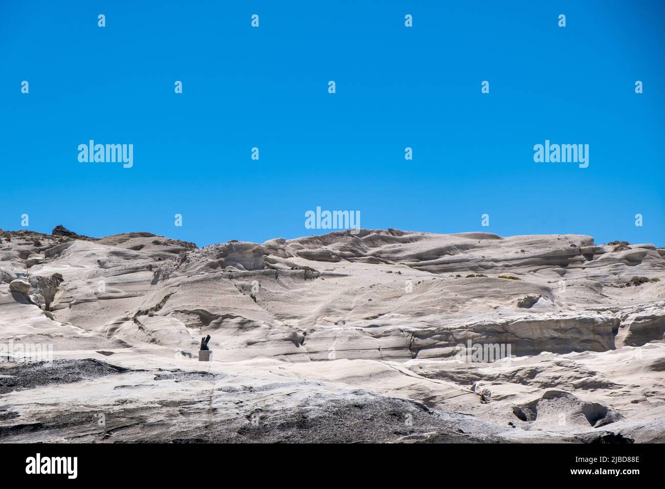 Lunar rock background at Sarakiniko Milos island, Cyclades Greece. Abstract natural white stone formation landscape, clear blue sky Stock Photo