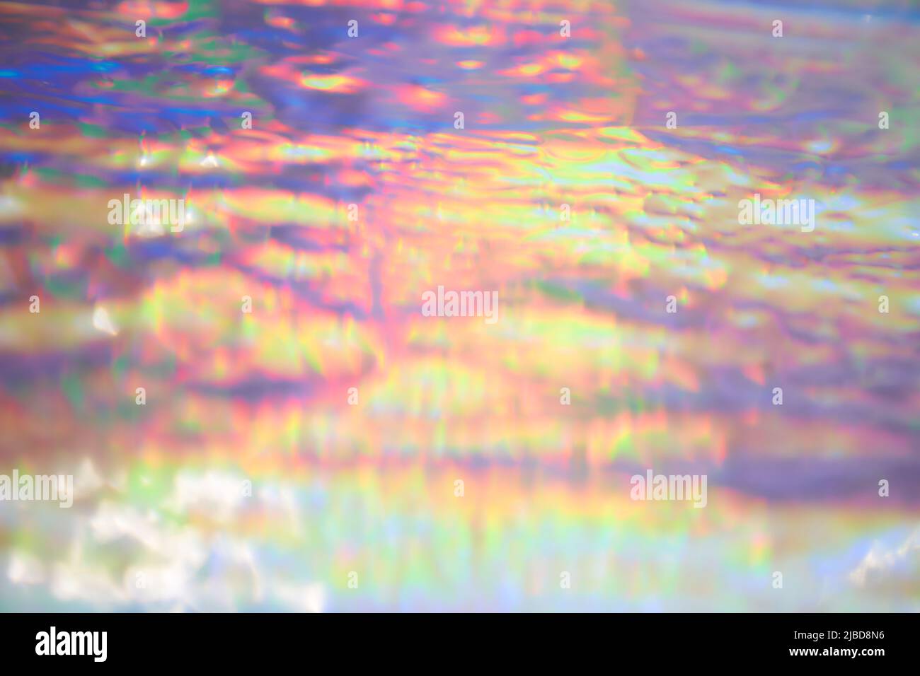Holographic iridescent background wrinkled wavy abstract rainbow blurred background. Surface with multiple colors of webpunk in 90's style. High quality photo Stock Photo