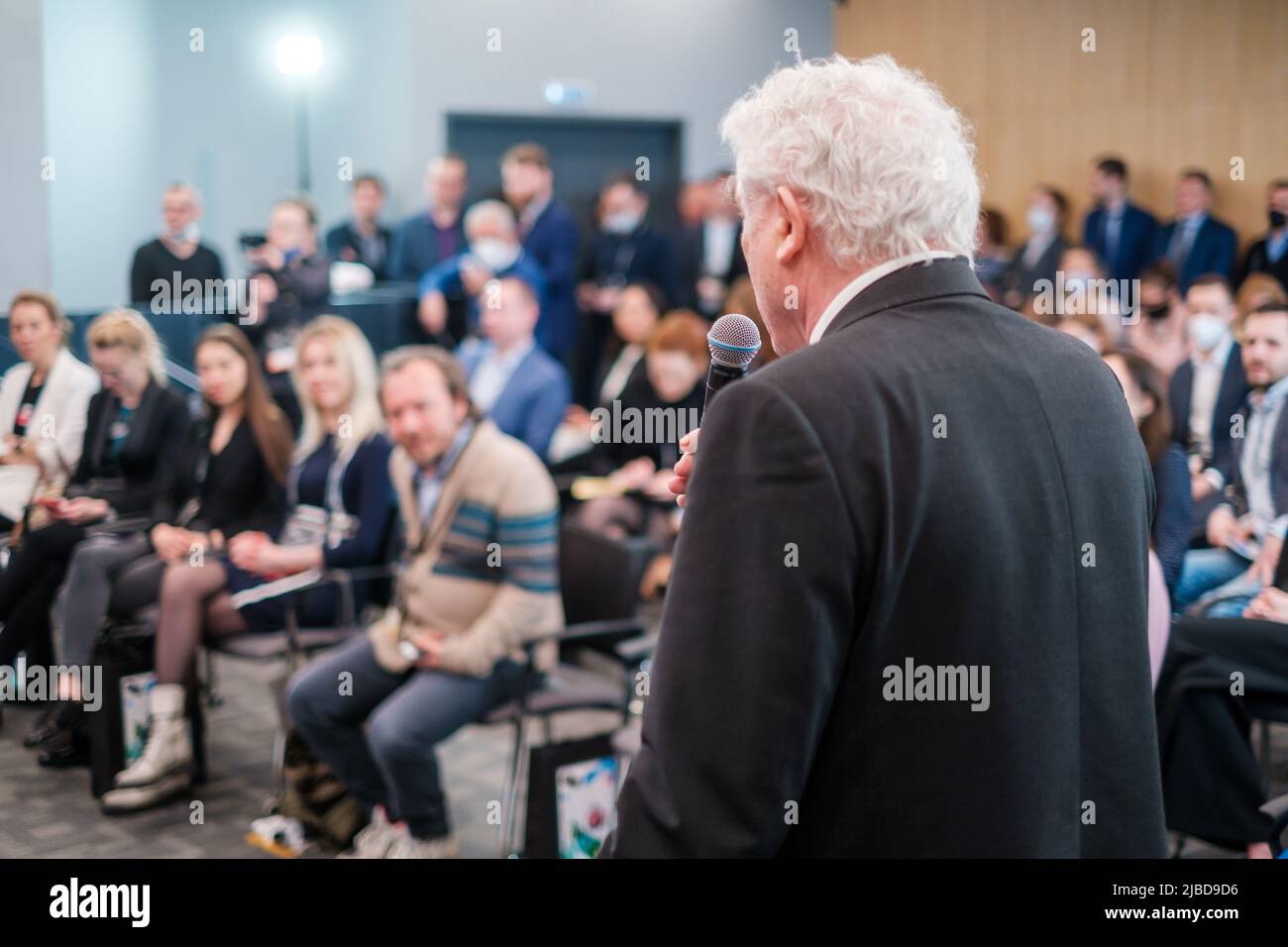 Elderly speaker talking to audience Stock Photo Alamy
