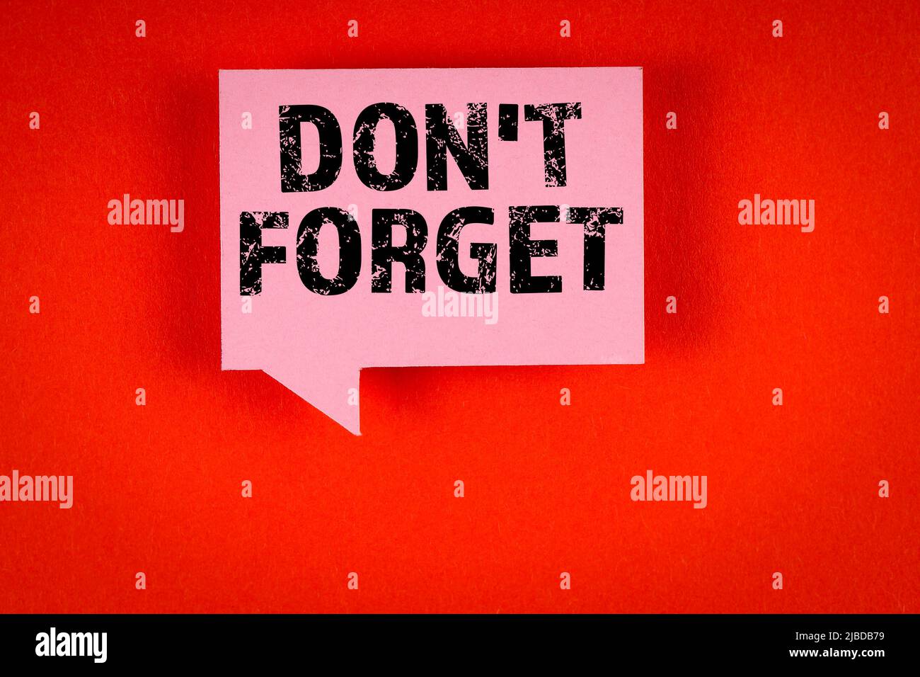 Don't Forget. Pink speech bubble on a red background. Stock Photo