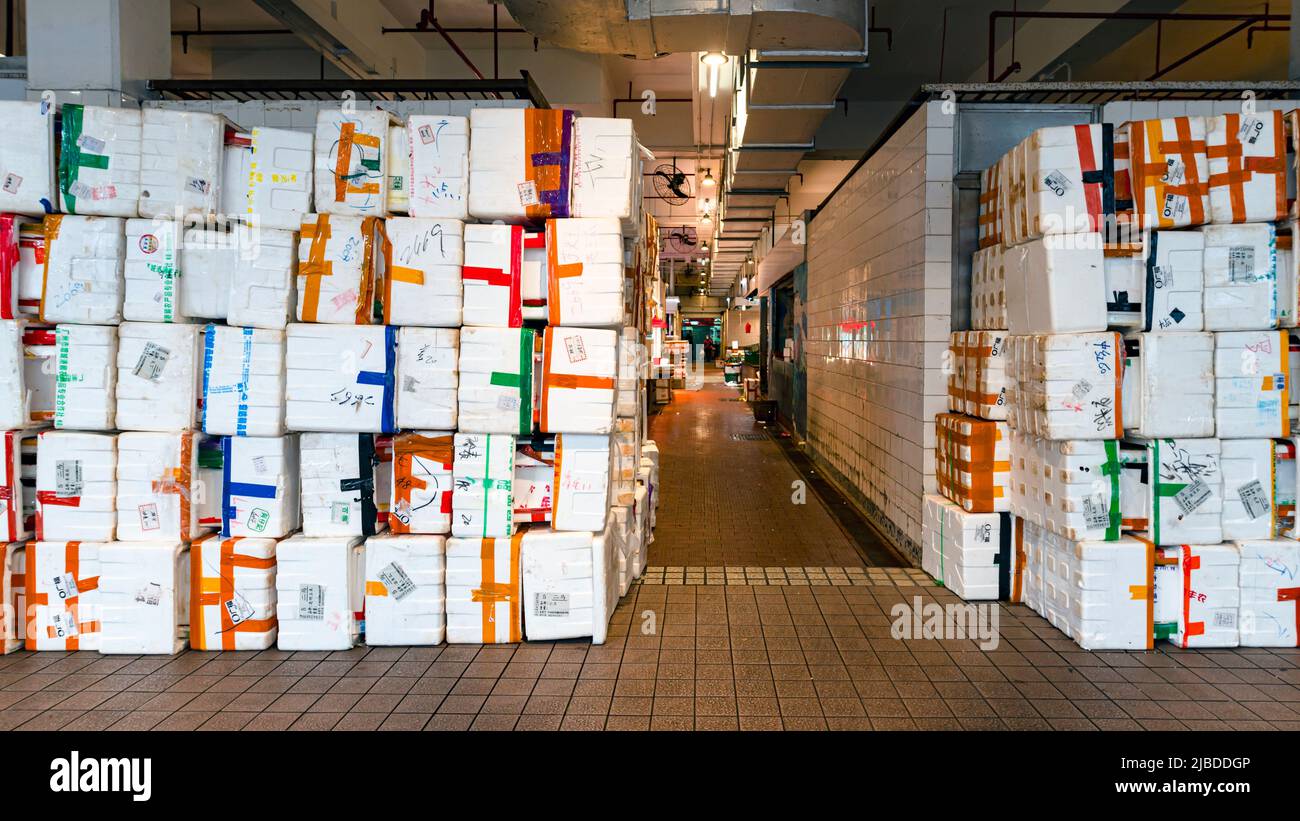 A wall of waste styrofoam boxes outside the wet market in Hong Kong. The tidiness of the boxes is a piece of art by the wet market hawker Stock Photo