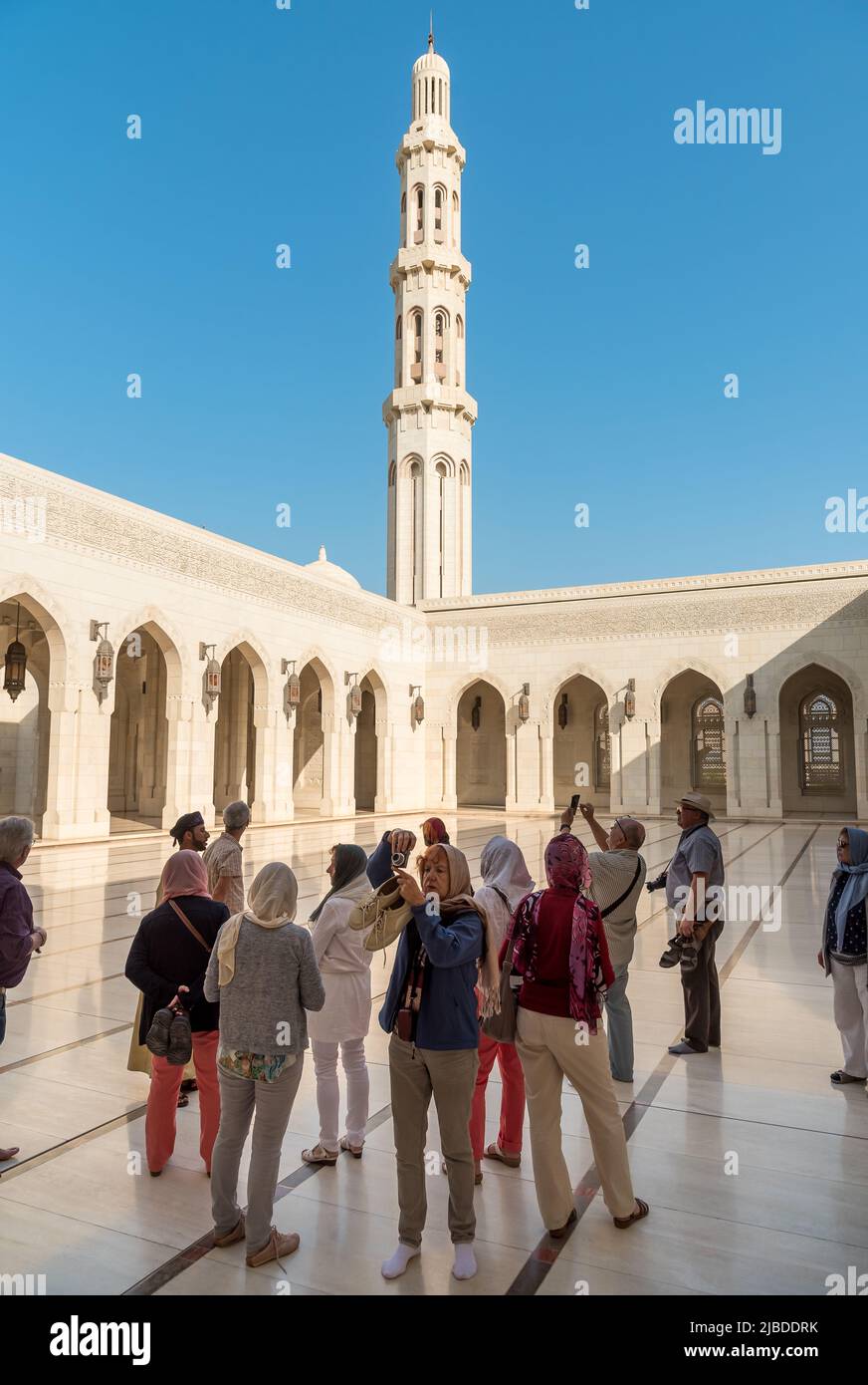 Muscat, Oman, Middle East - February 10, 2020: Tourists visiting the Sultan Qaboos Grand Mosque in Muscat. Oman tour. Stock Photo