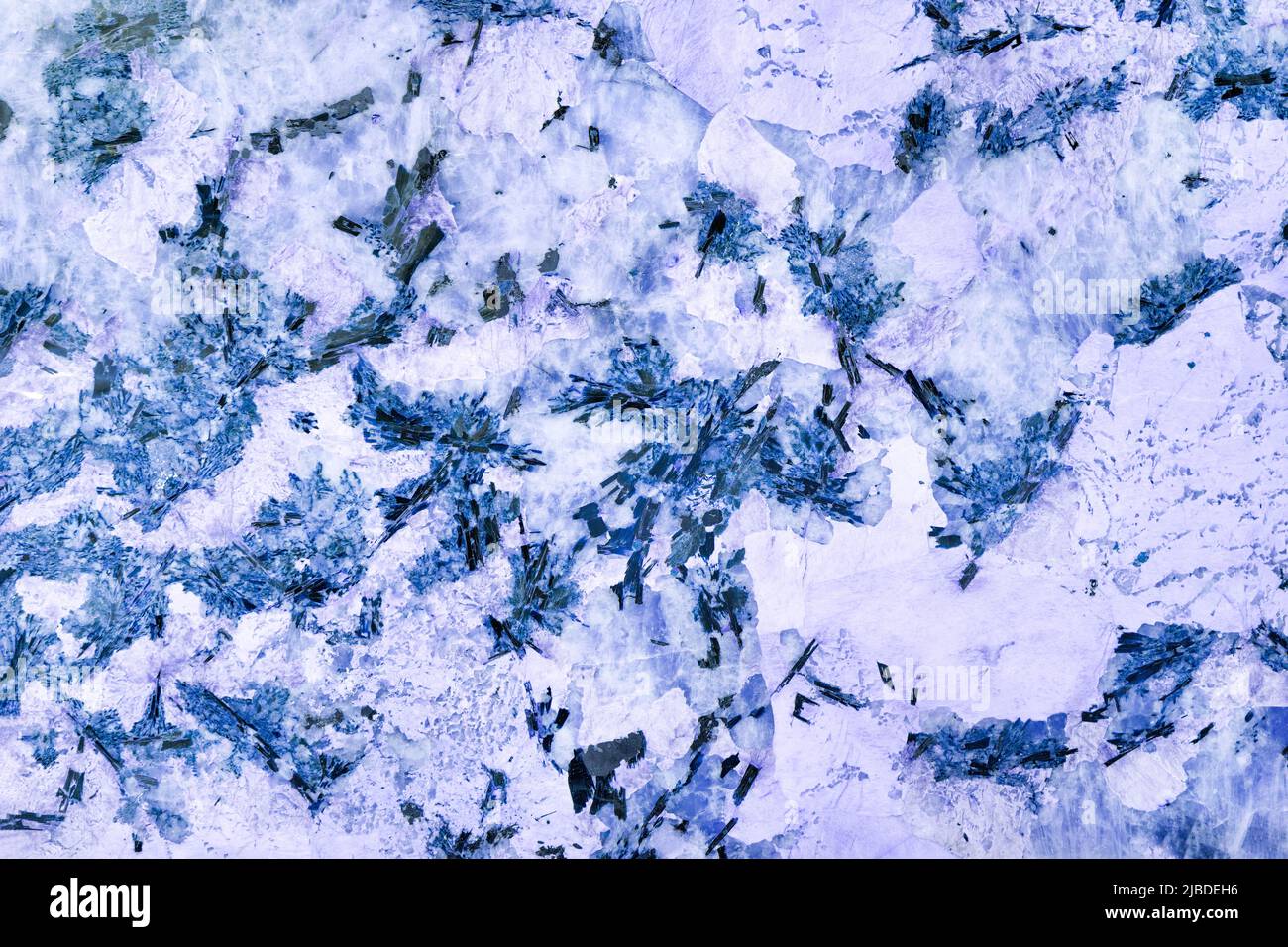 Marble texture of crystals of blue, purple marble with black inclusions