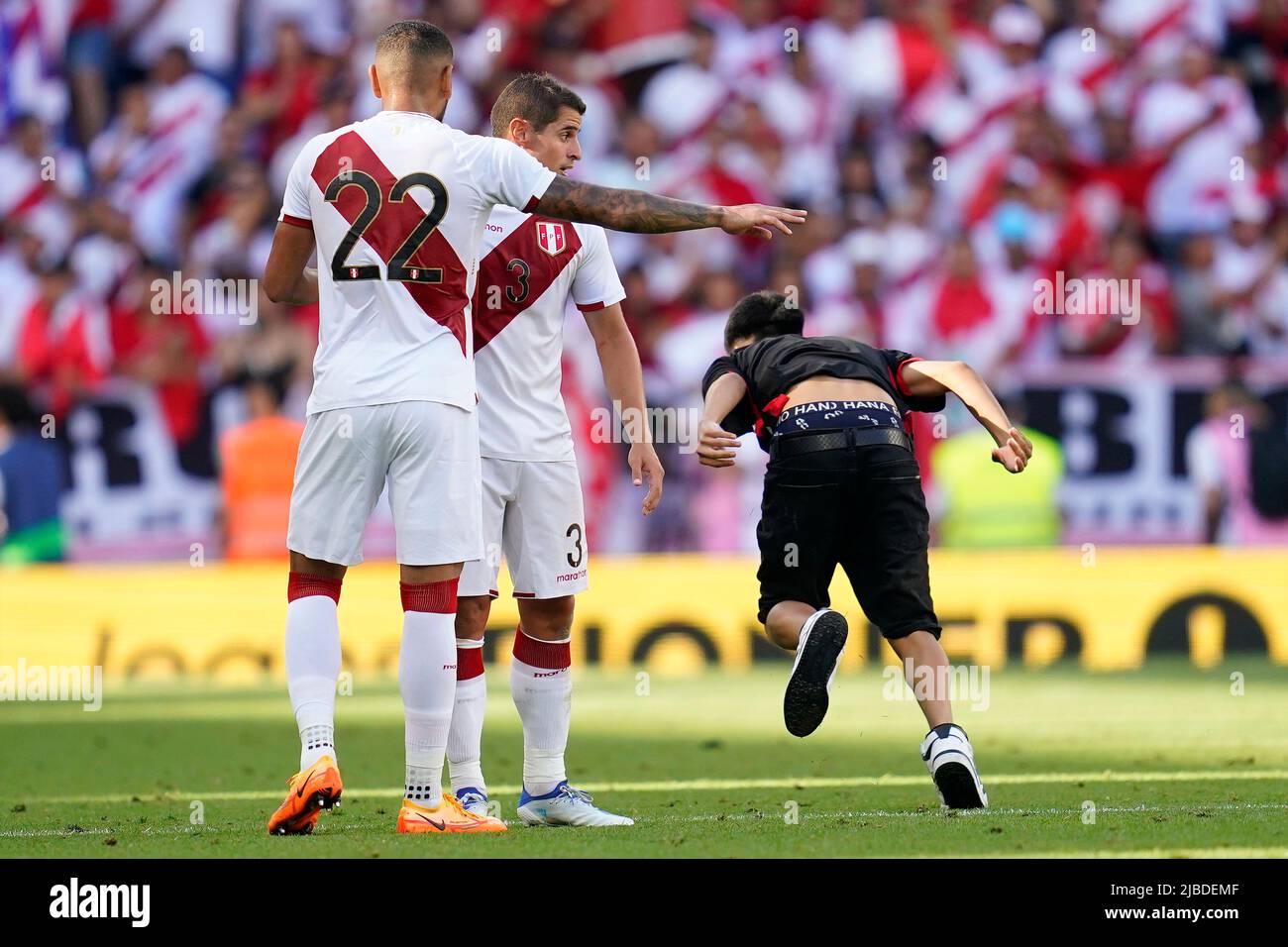 Barcelona, Spain. June 5, 2022, Alexander Callens and Aldo Corzo of Peru with a fan invading the field during the friendly match between Peru and New Zealand played at RCDE Stadium on June 5, 2022 in Barcelona, Spain. (Photo by Bagu Blanco / PRESSINPHOTO) Stock Photo