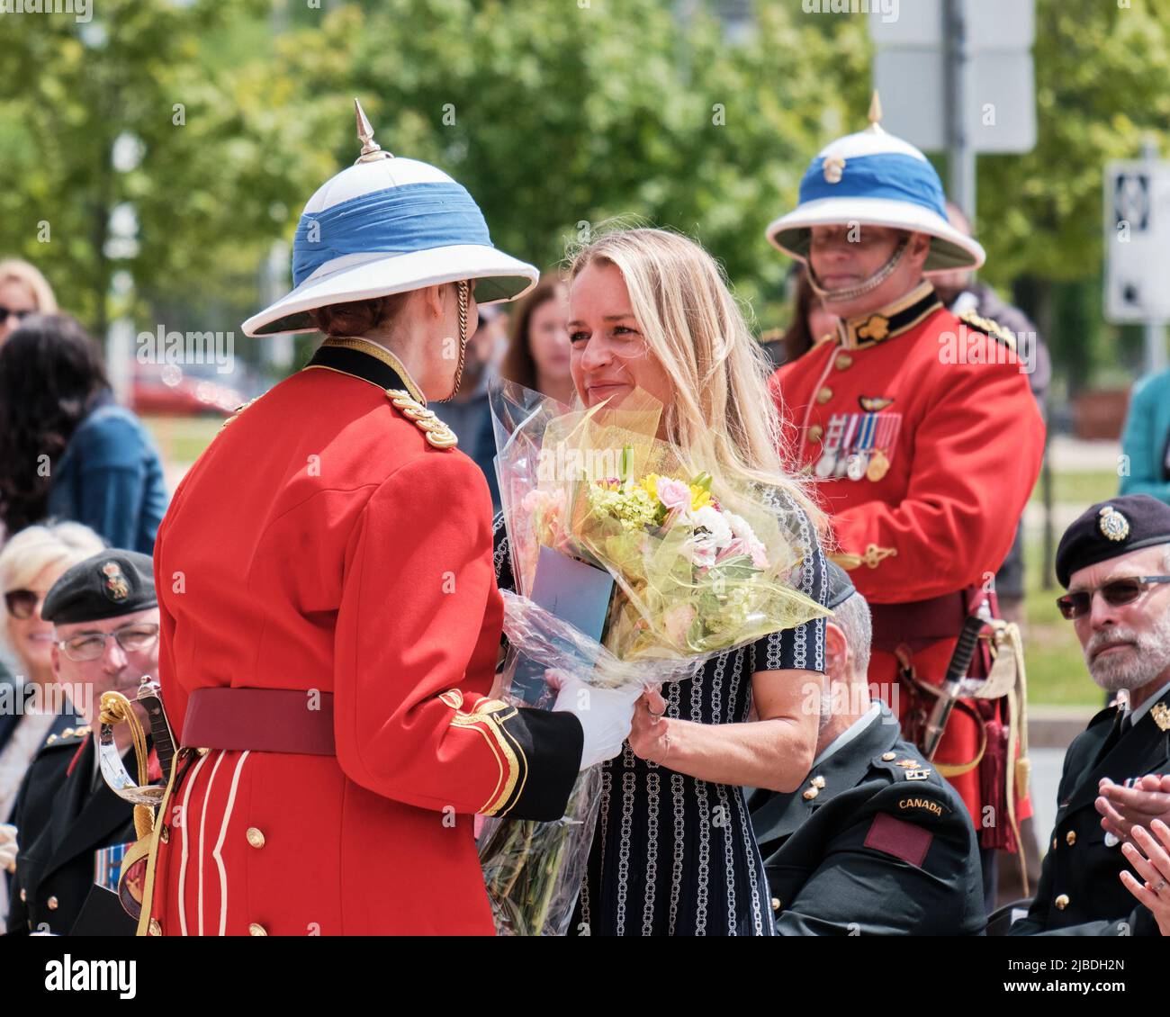 Halifax, Nova Scotia, June 5th, 2022. Lieutenant Colonel Rhonda Matthews takes over command of the Princess Louise Fusiliers at ceremony in Halifax. She here presents flowers to the wife of the exiting LCol Barry Pitcher seen behind. Credit: meanderingemu/Alamy Live News Stock Photo