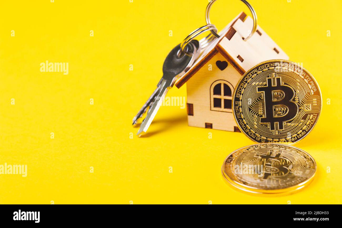 Buying real estate for cryptocurrency. Housing and bitcoins. Coins and  house keys. Small wooden house and bitcoin coin Stock Photo - Alamy