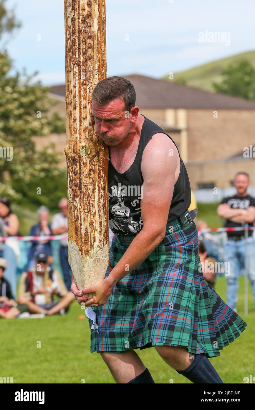 Girvan, UK. 05th June, 2022. After an absence of two years because of Covid restrictions, the Carrick Lowland Games returned to Girvan in South Ayrshire with the regular traditional highland dancing competitions, piping competitions and the ever popular heavyweight highland sports of tossing the stone, throwing the hammer, clearing the bar and tossing the caber. Some well known sports personalities attended including Neil Elliot, from Helensburgh, a former Champion of The Games. Credit: Findlay/Alamy Live News Stock Photo