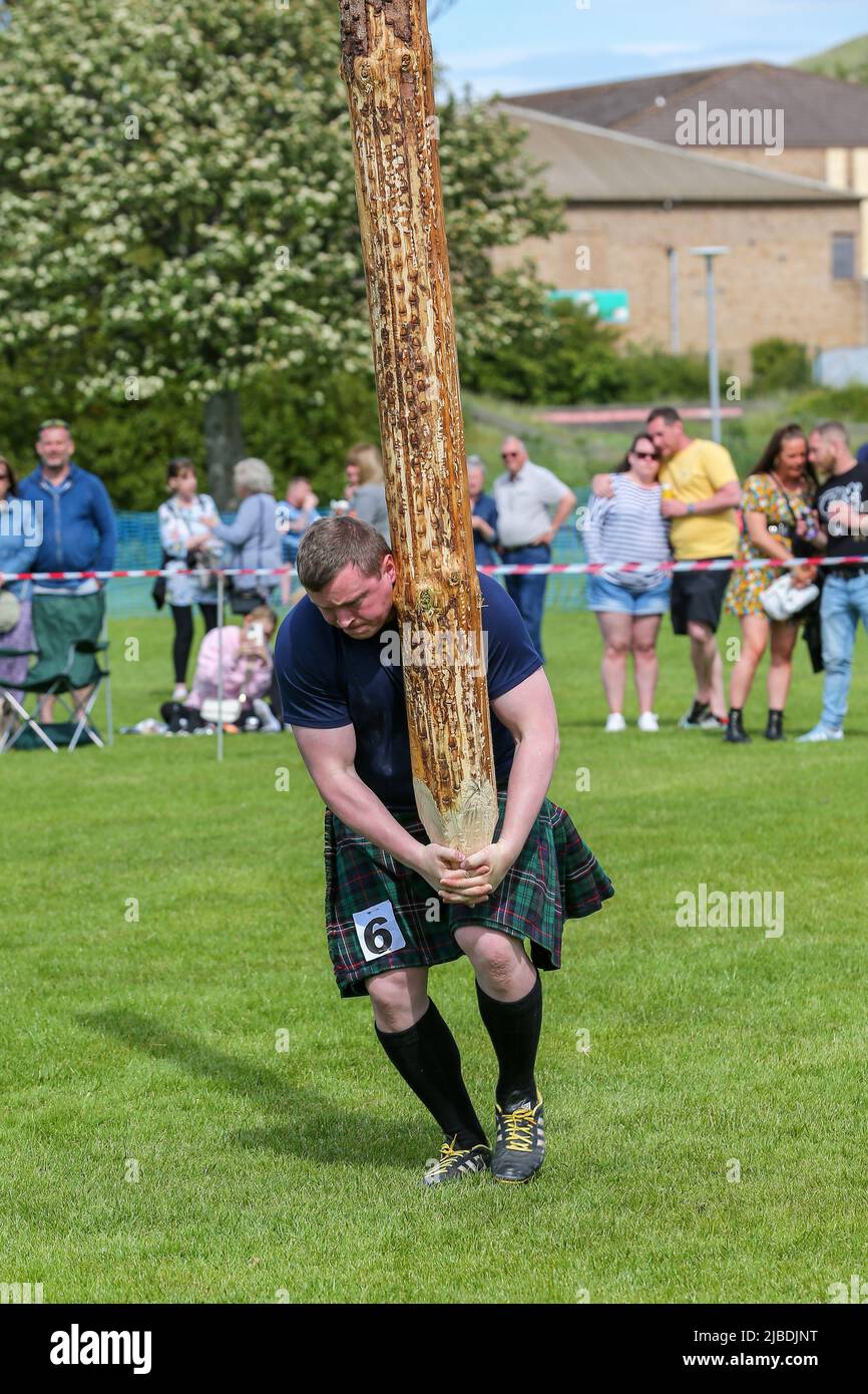 Girvan, UK. 05th June, 2022. After an absence of two years because of Covid restrictions, the Carrick Lowland Games returned to Girvan in South Ayrshire with the regular traditional highland dancing competitions, piping competitions and the ever popular heavyweight highland sports of tossing the stone, throwing the hammer, clearing the bar and tossing the caber. Some well known sports personalities attended including Neil Elliot, from Helensburgh, a former Champion of The Games. Credit: Findlay/Alamy Live News Stock Photo
