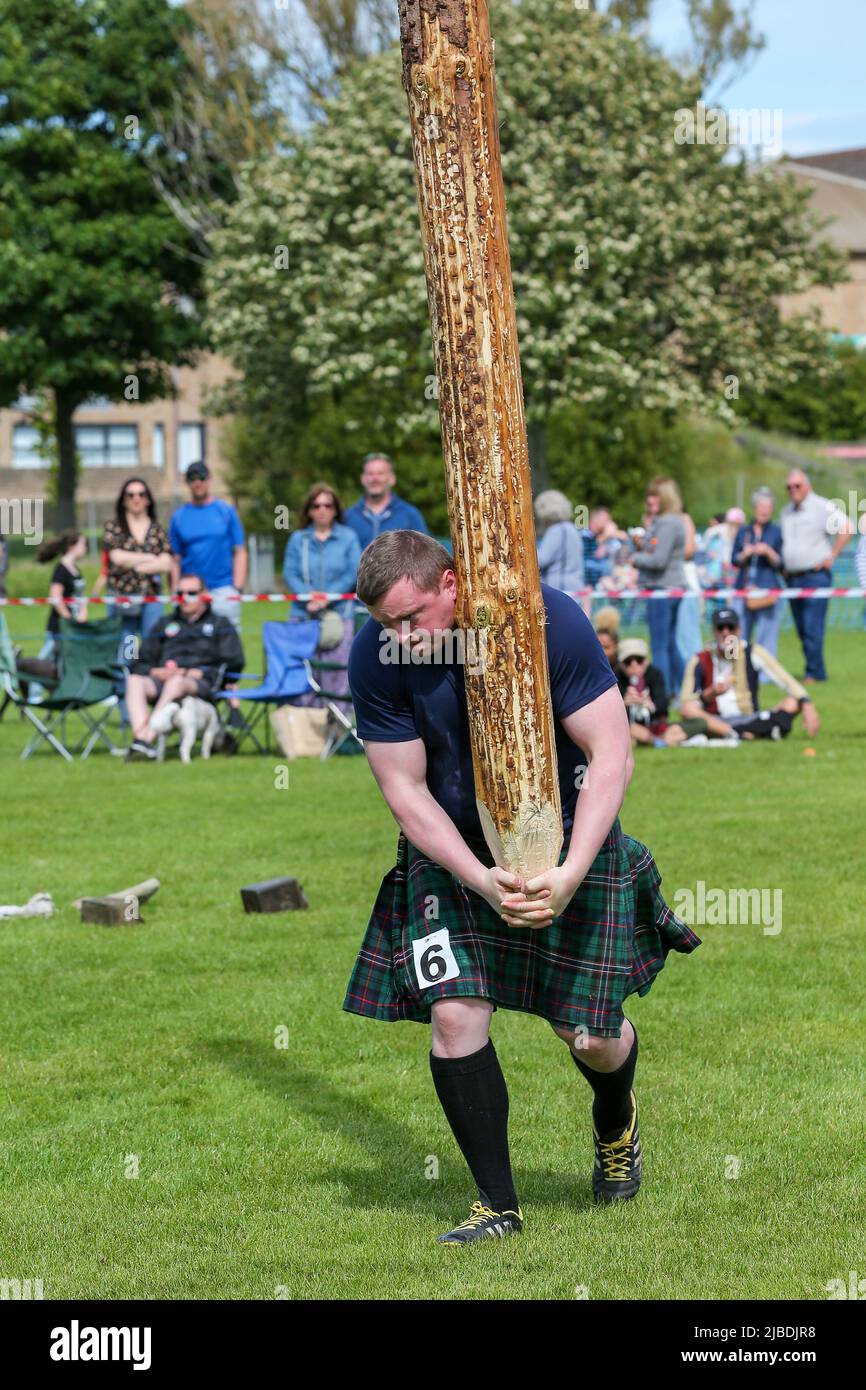 Girvan, UK. 05th June, 2022. After an absence of two years because of Covid restrictions, the Carrick Lowland Games returned to Girvan in South Ayrshire with the regular traditional highland dancing competitions, piping competitions and the ever popular heavyweight highland sports of tossing the stone, throwing the hammer, clearing the bar and tossing the caber. Some well known sports personalities attended including Neil Elliot, from Helensburgh, a former Champion of The Games. Credit: Findlay/Alamy Live News Stock Photo