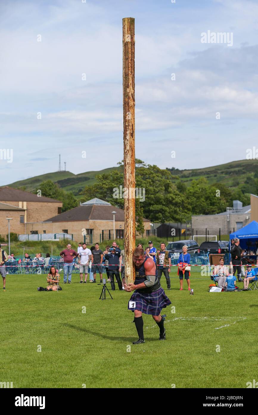 Girvan, UK. 05th June, 2022. After an absence of two years because of Covid restrictions, the Carrick Lowland Games returned to Girvan in South Ayrshire with the regular traditional highland dancing competitions, piping competitions and the ever popular heavyweight highland sports of tossing the stone, throwing the hammer, clearing the bar and tossing the caber. Some well known sports personalities attended including Neil Elliot, from Helensburgh, a former Champion of The Games. Credit: Findlay/Alamy Live News Stock Photo