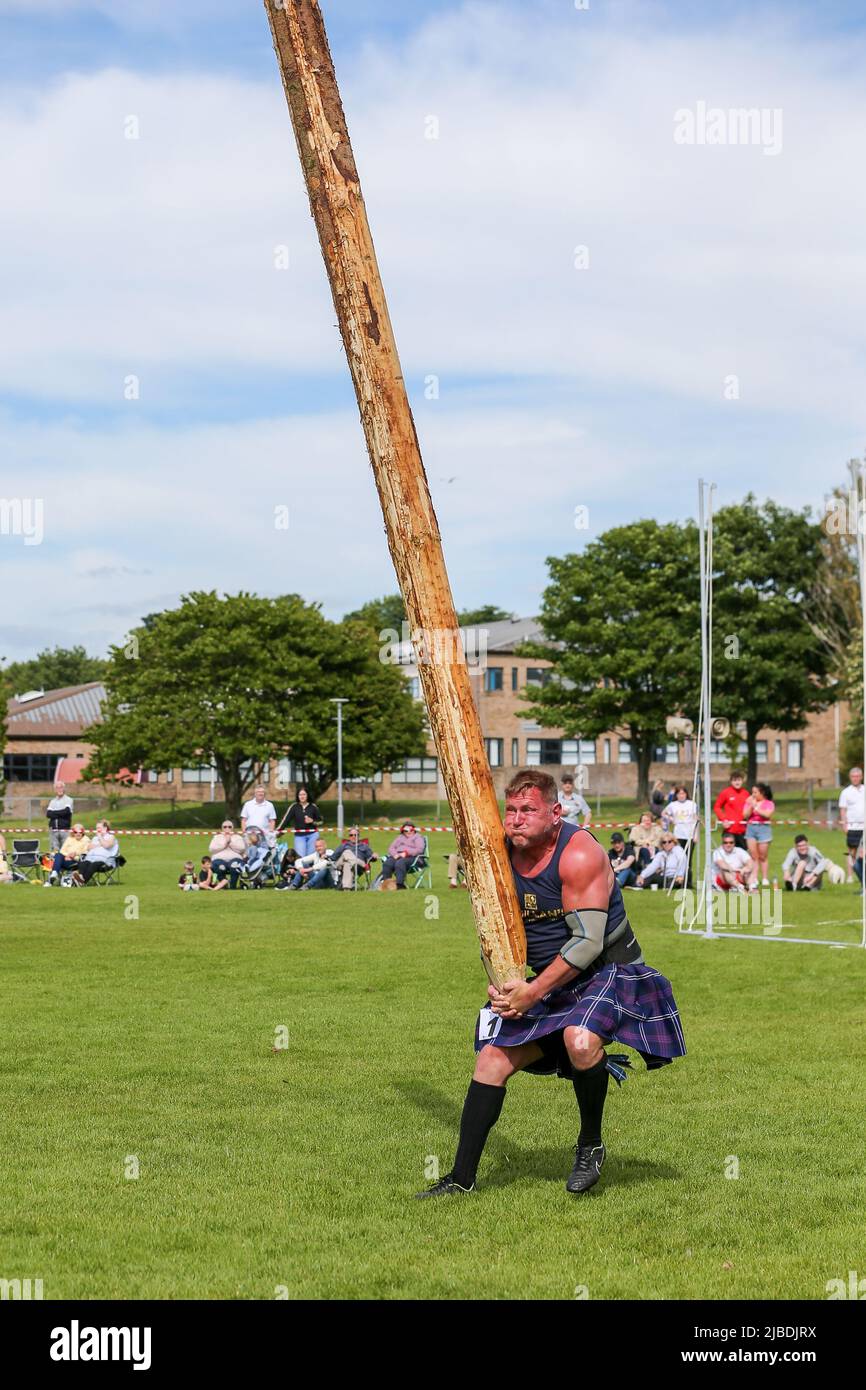 Girvan, UK. 05th June, 2022. After an absence of two years because of Covid restrictions, the Carrick Lowland Games returned to Girvan in South Ayrshire with the regular traditional highland dancing competitions, piping competitions and the ever popular heavyweight highland sports of tossing the stone, throwing the hammer, clearing the bar and tossing the caber. Some well known sports personalities attended including Neil Elliot, from Helensburgh, a former Champion of The Games. Credit: Findlay/Alamy Live News Stock Photo