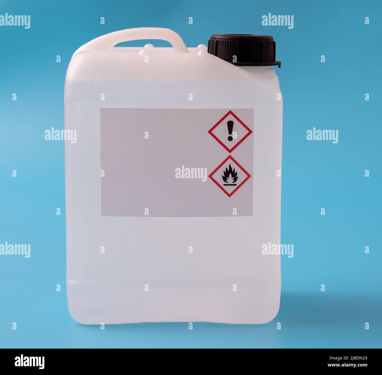 plastic canister with hazard symbols on blue background Stock Photo