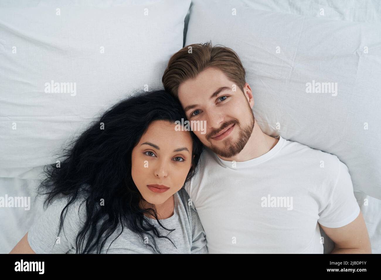 Man and his beloved lady resting in bedroom Stock Photo