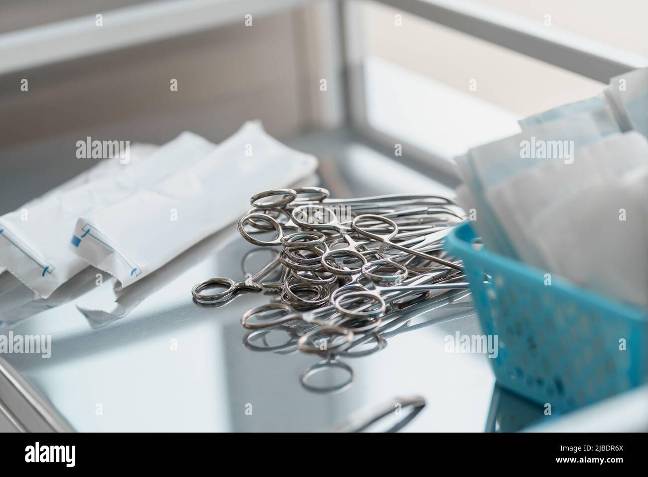 Surgical instruments such as forceps arranged on table for surgery Stock Photo