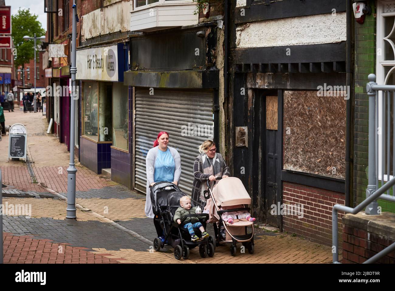 Mums with prams Sutton-in-Ashfield is a market town in Nottinghamshire near  Mansfield closed down shops in the town centre Stock Photo