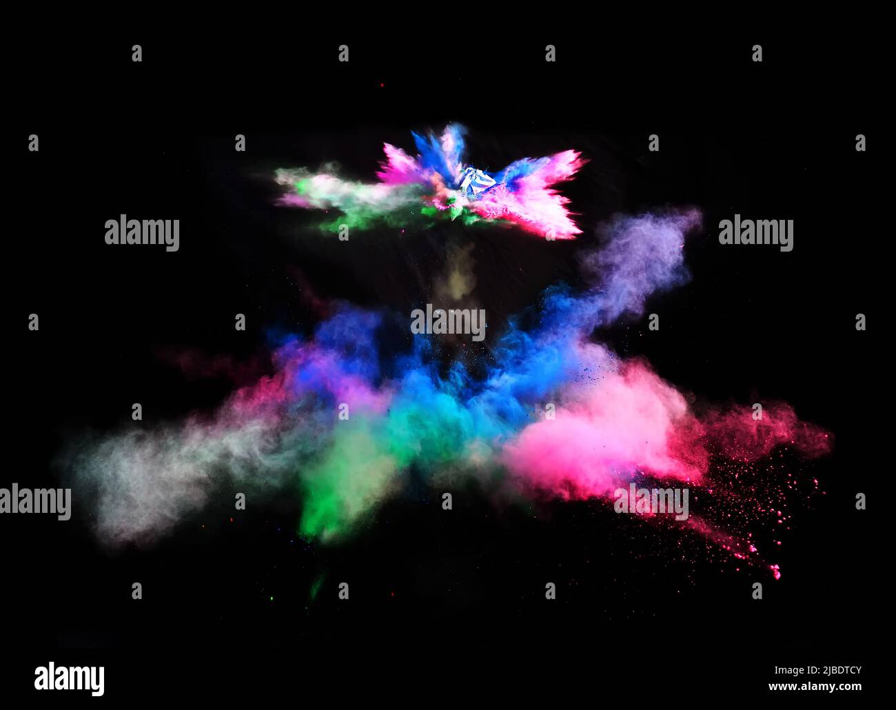 Various multicolored forms of powder paint explode in front of a black ...