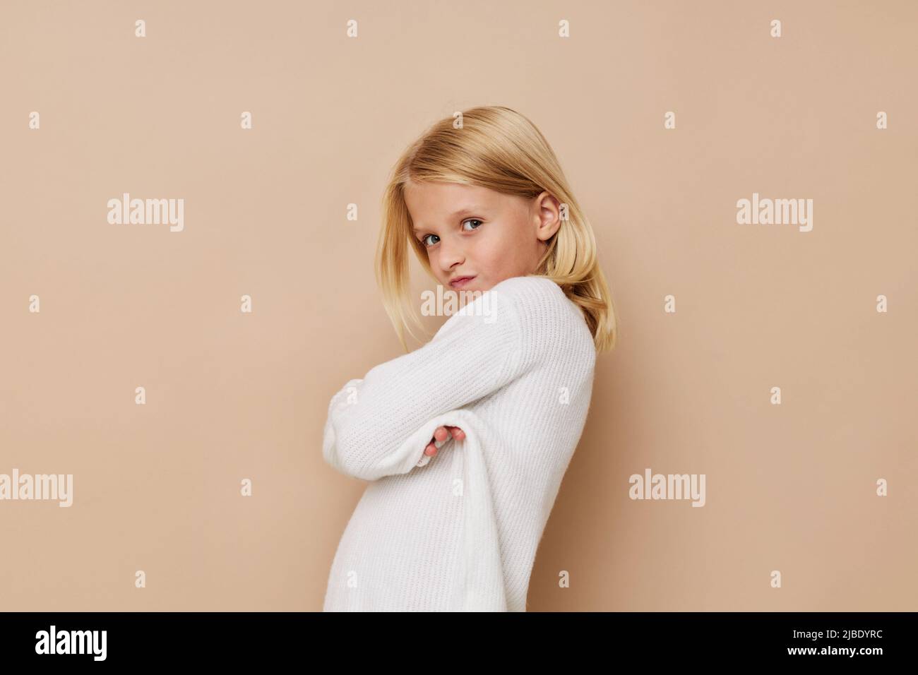 Little cute girl with blond hair posing studio Stock Photo - Alamy