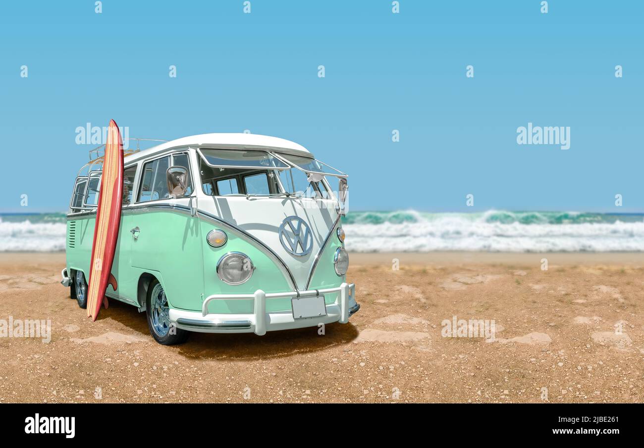 Acapulco - Mexico – July 16, 2019: Calssic 1966 Volkswagen Bus with surfboard front view at the beach with sea and blue sky in the background. Stock Photo