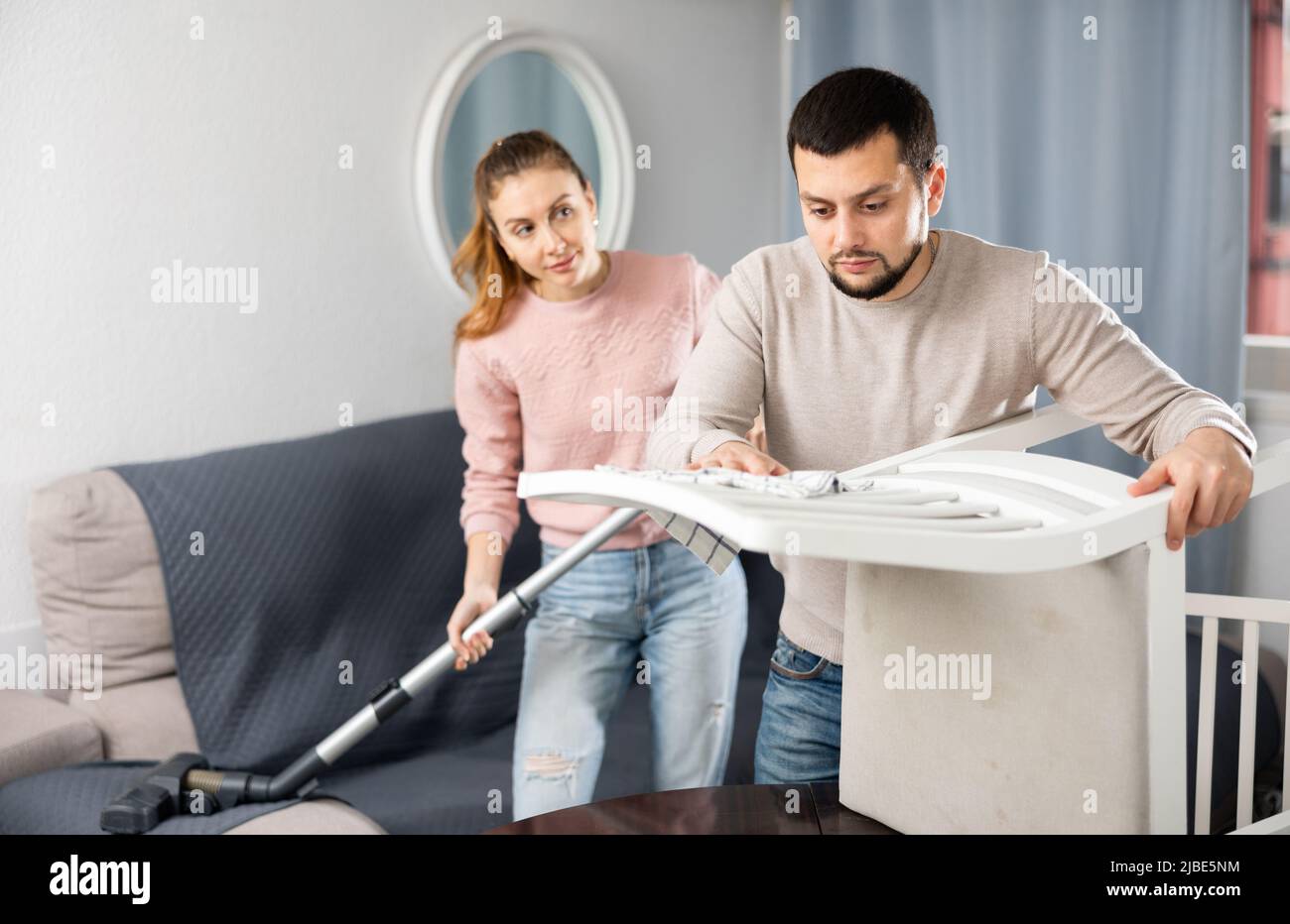 Wife and husband cleaning up in apartment Stock Photo Alamy