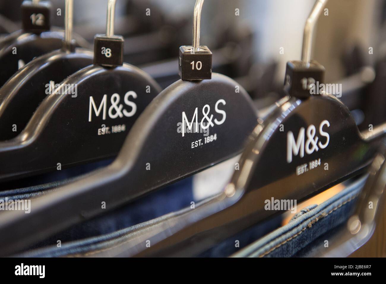 Clothing hangers in a Marks & Spencer store Stock Photo