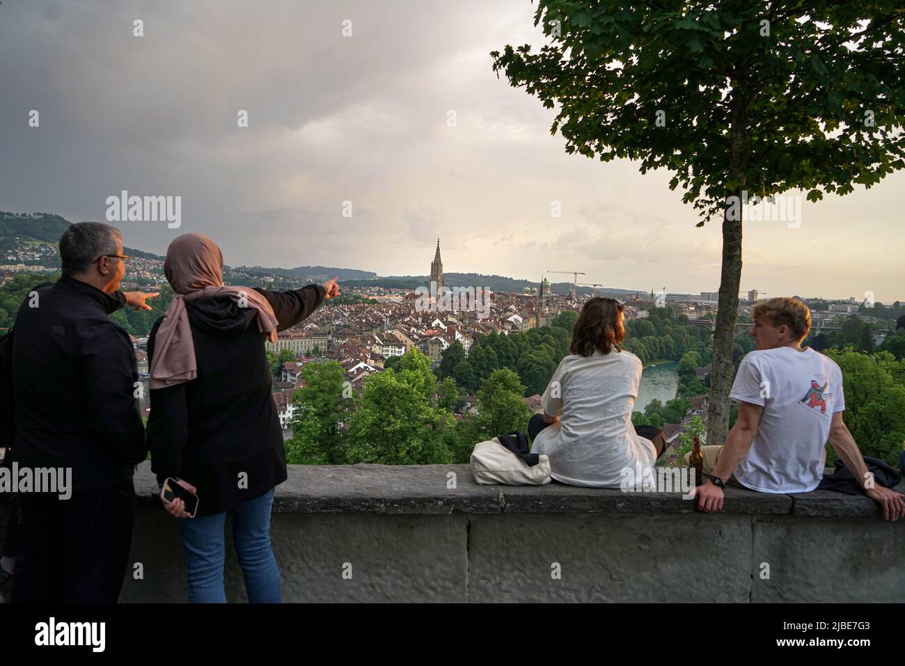 People admiring the splendid panoramic view of the old city of Berne from above. Bern, Switzerland - June 2022 Stock Photo