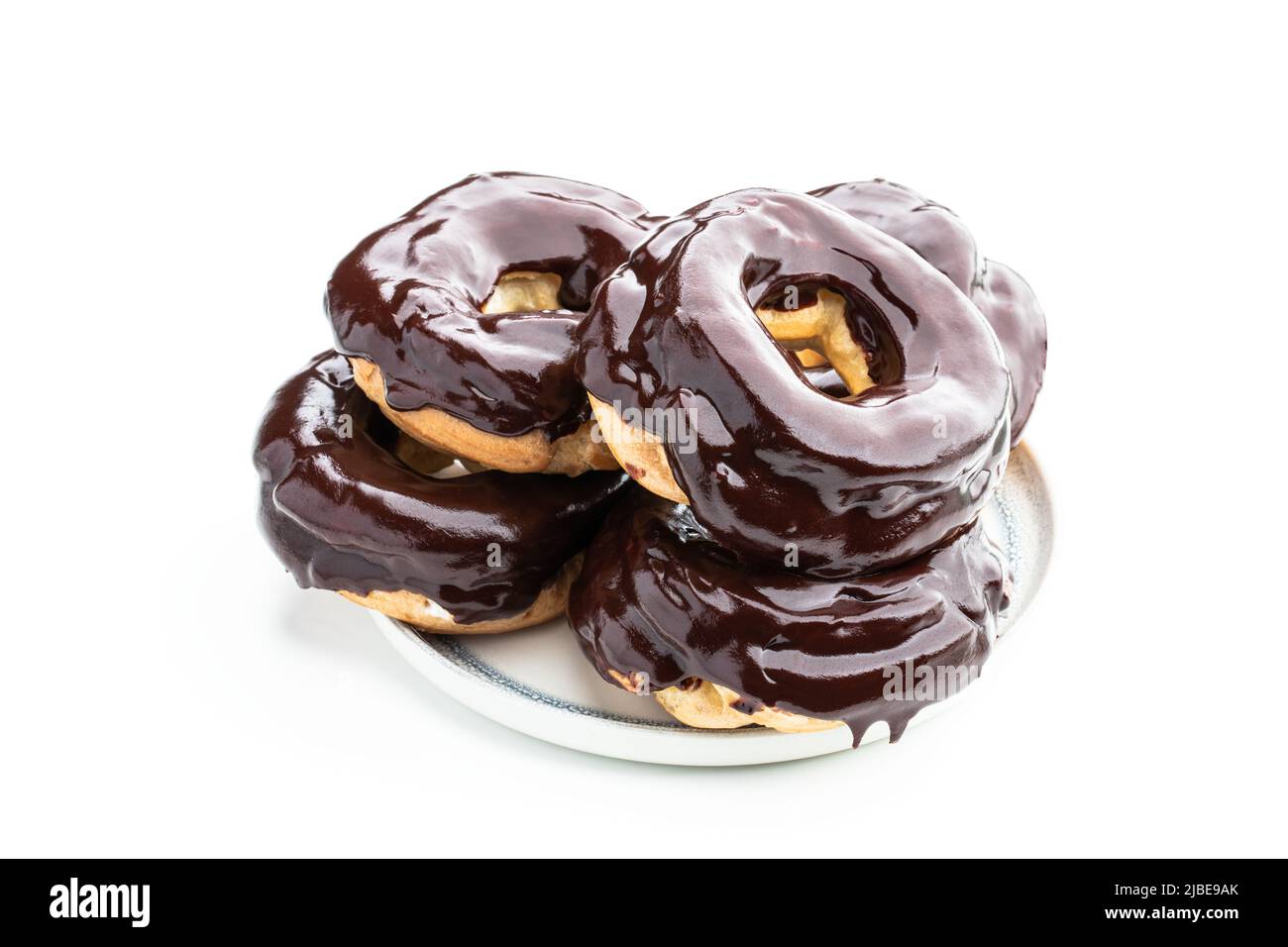 Ring-shaped  dark chocolate covered eclairs isolated on white Stock Photo