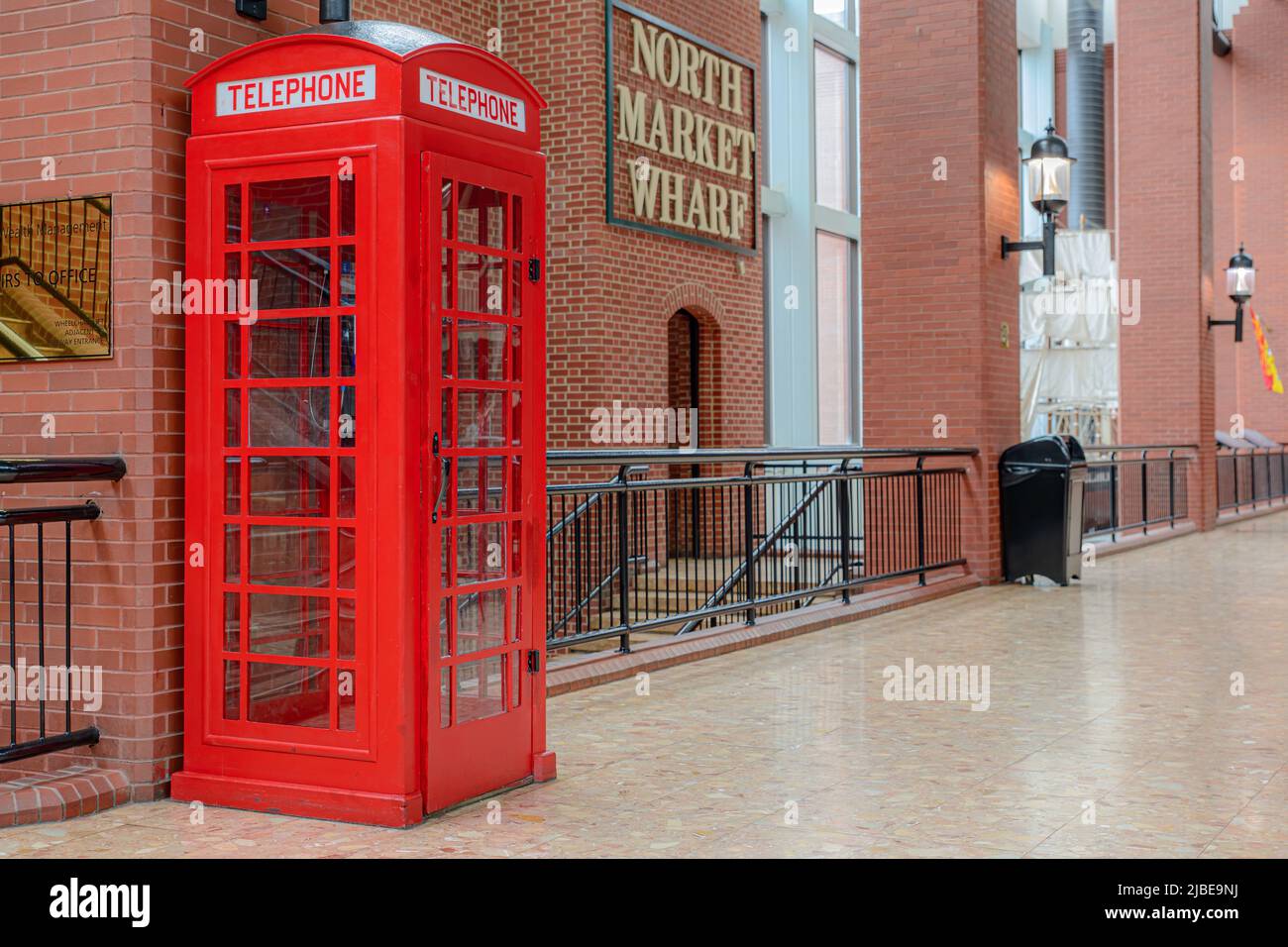 Saint John, NB, Canada - June 5, 2022: A red phone booth. The booth is the famous British K6 design, but without the crown at the top. Stock Photo