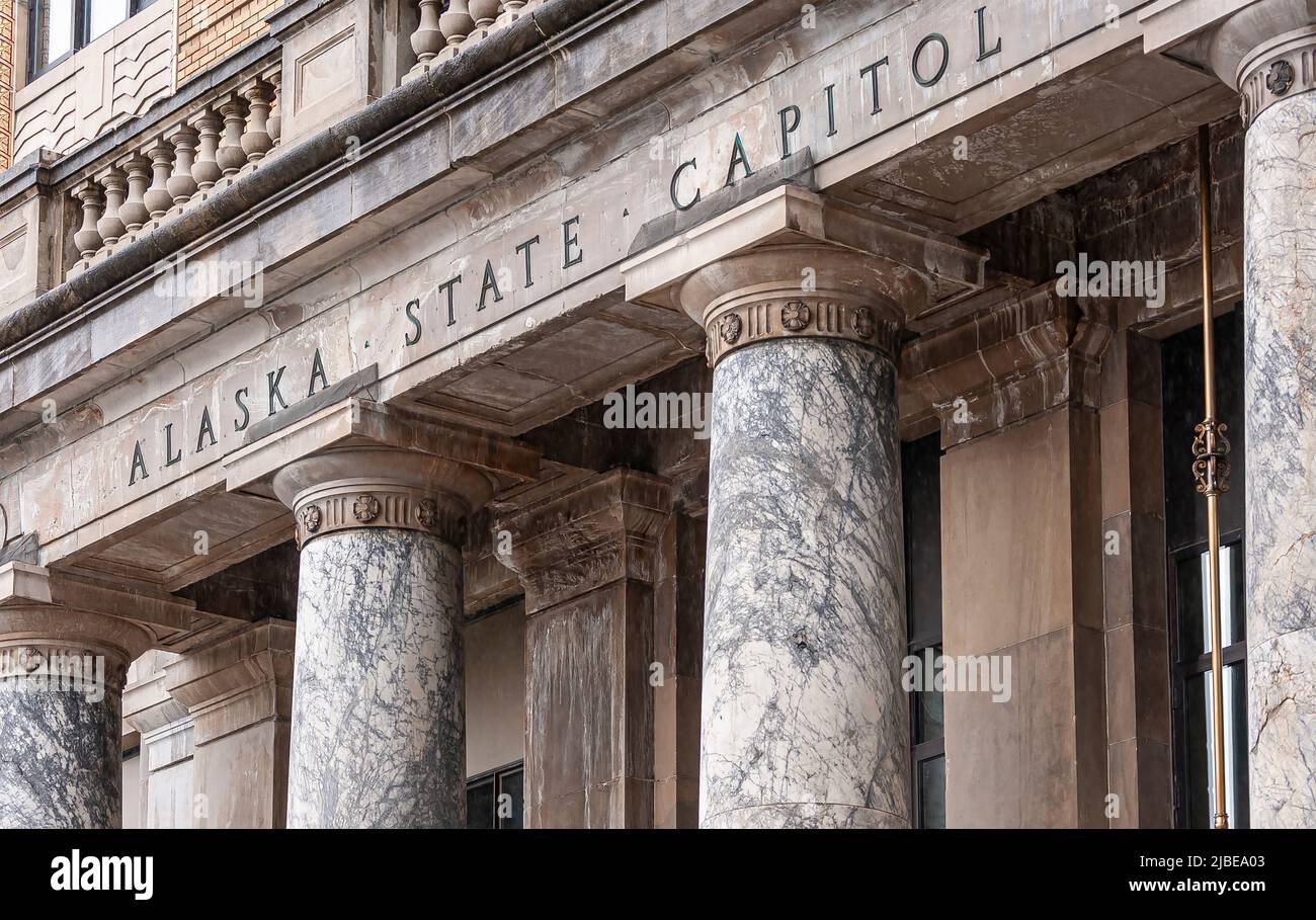 Juneau, Alaska, USA - July 19, 2011: Closeup, Frieze of Alaska State Capitol, stating as much, on top of marble pillars. Brown stone building. Stock Photo