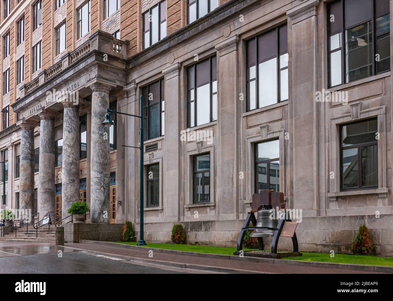 Juneau, Alaska, USA - July 19, 2011: Front facade with main entrance and Liberty bell of Alaska State Capitol. Stock Photo