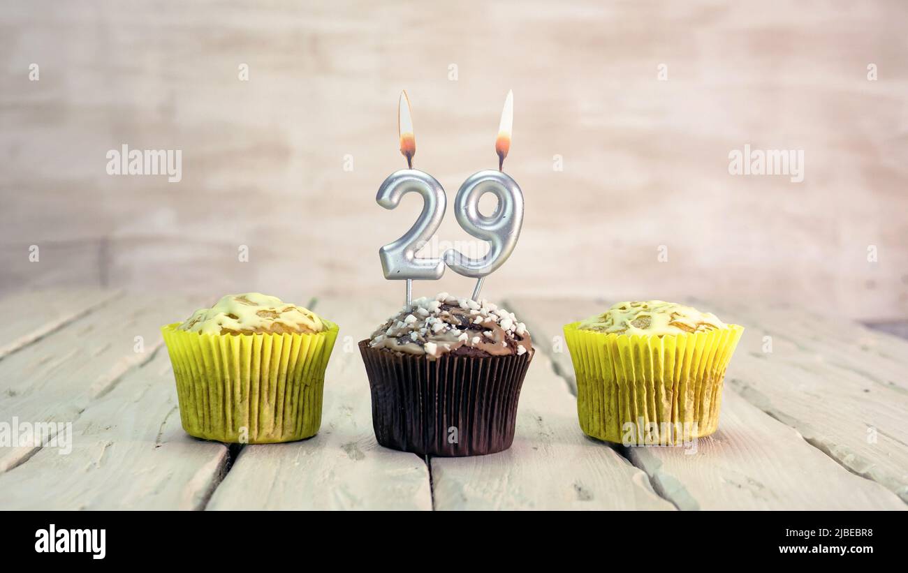 Happy birthday muffins with candles with the number. Card copy space with pies for congratulations. Stock Photo