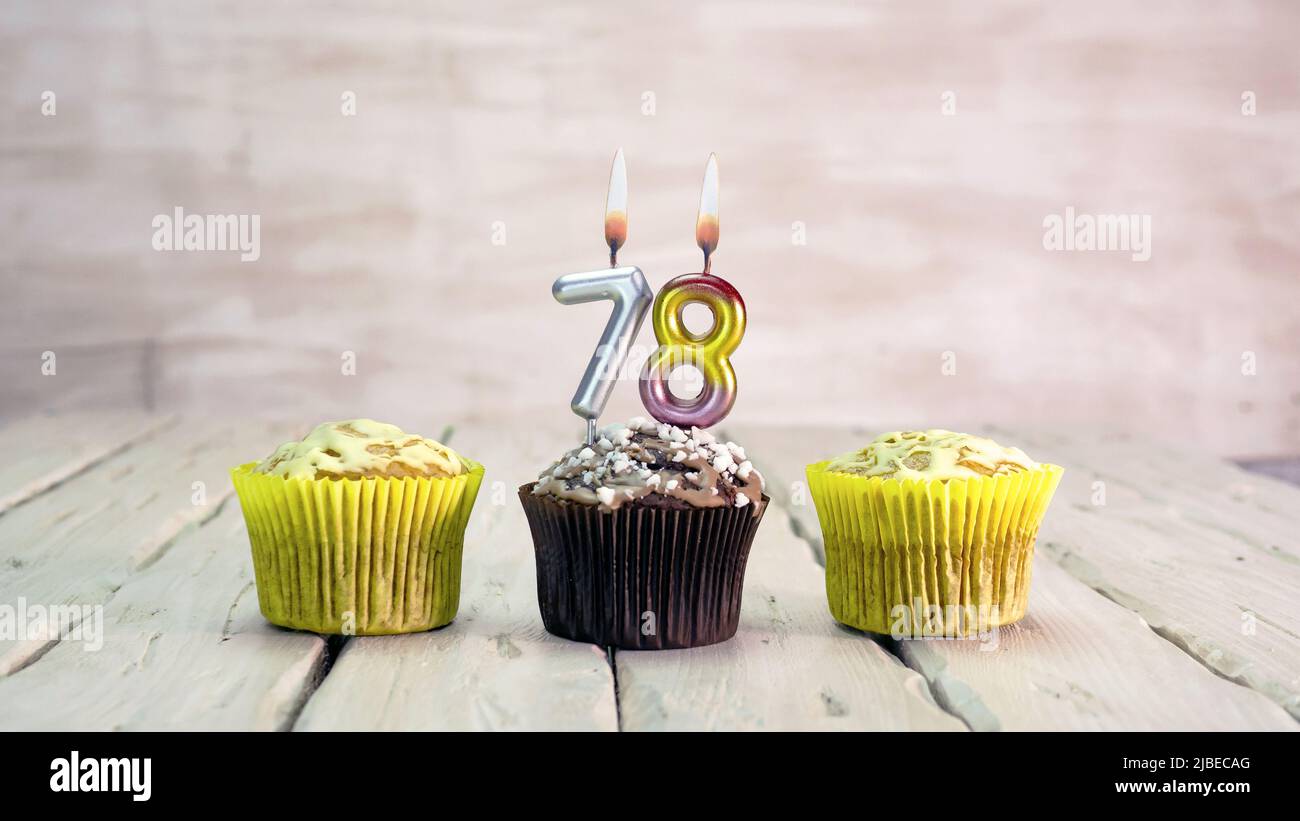 Happy birthday muffins with candles with the number. Card copy space with pies for congratulations. Stock Photo